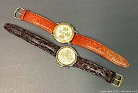 Two CAMPARI chronograph watches, one with an orange leather strap, one with a brown leather strap, both with stainless steel cases.