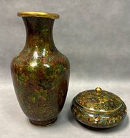 Front view of the vase and vanity jar showing floral cloisonné enamel pattern.