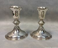 Front view of two vintage BIRK sterling silver candleholders showing the shape and polished finish.