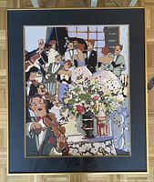Photo shows the full framed poster depicting a colorful, stylized ball scene with musicians and guests. The frame has a dark blue mat and black border with gold trimming, poster is 20x24 inches.
