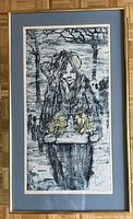 Framed watercolour print showing a young girl holding a tray of yellow daffodils in a wintry scene with bare trees, matted in blue-grey matte and framed with metallic frame.