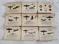 Nine individual vintage Sweet Caporal Cigarettes Aircraft Spotter Series military aircraft trading cards laid out in a grid arrangement showing various planes illustrated side and top views.