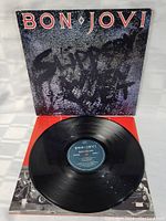 Front cover of 'Slippery When Wet' album with vinyl record in front and inner sleeve partly visible underneath.