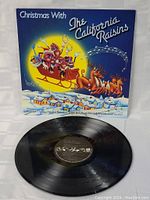 Photo of the vinyl record on a white surface showing the record label and part of the cover.