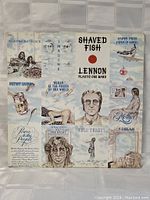 Front cover of John Lennon Shaved Fish album showing collage art and portraits with text 'SHAVED FISH' and 'LENNON PLASTIC ONO BAND'.