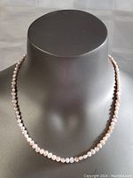 Full view of the 19-inch freshwater pearl necklace on display, showing pearl shape, size, and overall strand length.