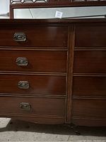Close-up view of dresser drawers showing dovetail joinery and metal handles.