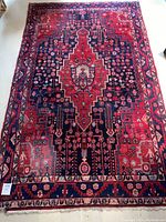 Full view of red and navy geometric oriental rug