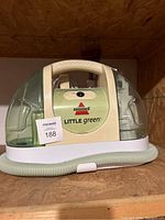 Front view showing the main body, handle, and translucent tanks