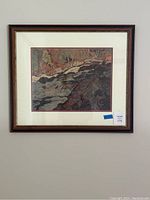 Framed nature print hung on wall showing the full artwork with wooden frame and white matting.