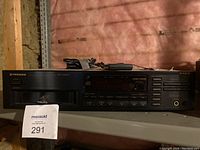 Front view of Pioneer PD-M415 CD changer with label and power cord on top.