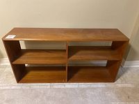 Front view of wooden shelving unit showing four compartments