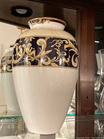 Photo of the full vase showing white bone china body with detailed dark blue and gold classical design band around the upper section.