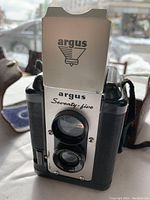 Front view of vintage Argus Seventy-Five twin lens camera showing brand and lens arrangement.