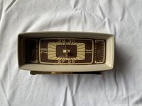 Front view of the mid-century modern Taylor Instrument barometer featuring a rectangular cream plastic frame, brown dial with pressure, temperature and humidity scales, and needle indicators.