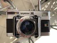 Front view of camera showing lens extended and Voigtländer logo