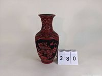 Full view of the cinnabar-style vase showing overall shape and floral-bird designs with a measurement card indicating 12 1/4 inches tall.