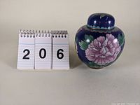Front view of cloisonne ginger jar with floral design and measurement reference showing 5 3/8 inches
