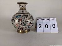 Front view of the cloisonne vase with floral and bird motifs, showing the full round body, brass base, and neck collar.