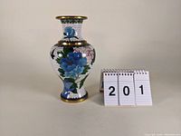 Front view of the 8-inch cloisonne vase with floral decorations and metal rims.