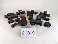 Overview of 15+ Chinese carved wood display stands in various shapes and sizes arranged on a white surface.