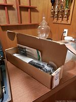 Box partially open showing the set of knives in their packaging on a table.