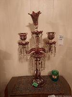 Front view of cranberry glass lustre candelabrum on table
