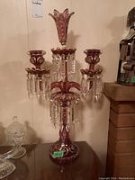 Front view showing three branch candle holders and central trumpet vase