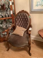 Front view of chair showing tufted back and cushioned seat