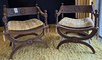 Two matching carved wood chairs side by side on mustard carpet
