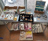 Overall table display of all boxes and trays of jewelry