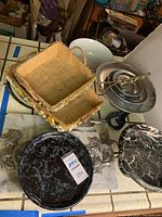 Two marble platters with silver leaf handles, wicker casserole dish holders, and the 4 tier dessert display plates in background.