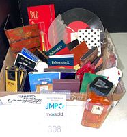 Box containing multiple small perfume samples, cards, and small vials from various designer brands including Fahrenheit and Fendi