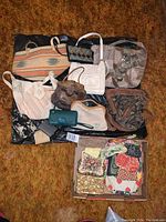 Photo displaying multiple vintage purses and wallets laid out on a surface showing different styles and materials