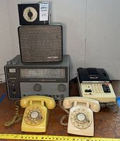 Full lot view showing all six items: two rotary telephones, shortwave receiver, speaker, credit balance machine, and antenna rotor.