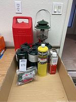 Full lot showing all fuel cylinders, lantern, and funnel in cardboard box