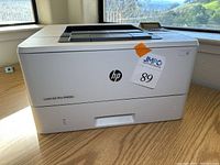 Front view of HP LaserJet Pro M402n showing logo and model number.