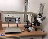 Overview of TeleSensory Chroma CCD magnifier on stand and stereo microscope on table