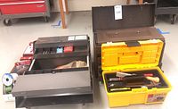Overall view of metal toolbox and yellow 3M Porter Cable toolbox side by side