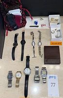 Full lot overview showing watches, wallet, and jewelry.