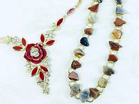 Two necklaces on white background showing details of rose pendant and natural stone beads.