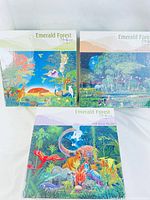 Three Emerald Forest puzzle boxes showing African animals, Australian animals, and dinosaurs themes
