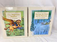 Two hardcover books: The Magician's Nephew and The Lion, the Witch and the Wardrobe by C.S. Lewis with illustrated covers from the Chronicles of Narnia series.