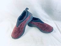 Pair of women's Merrell burgundy suede slip-on shoes showing front and side angles on white background.