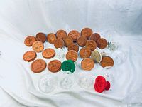 Wide shot displaying the assortment of terra cotta and plastic cookie molds and presses spread on white background.