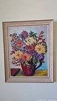 Full view of the framed oil painting showing floral bouquet in red vase.