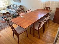 Full view of extended table with six chairs arranged around