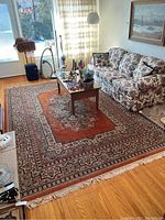 Full room view showing entire rug under coffee table and sofa