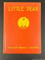 Front cover showing orange cloth binding with yellow title 'Little Pear' and author 'Eleanor Frances Lattimore' along with an illustration of a boy's face.