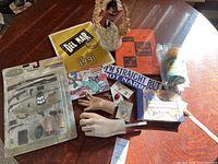 Full view of all items showing model accessories, catalog, hands, sticker, doll and jewelry.